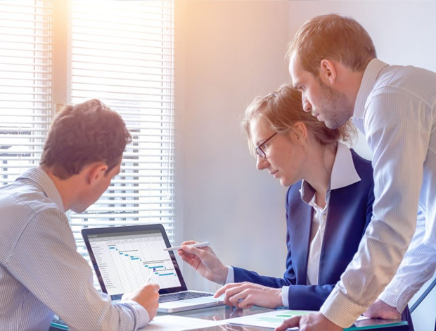 Team viewing charts and analytics on a computer