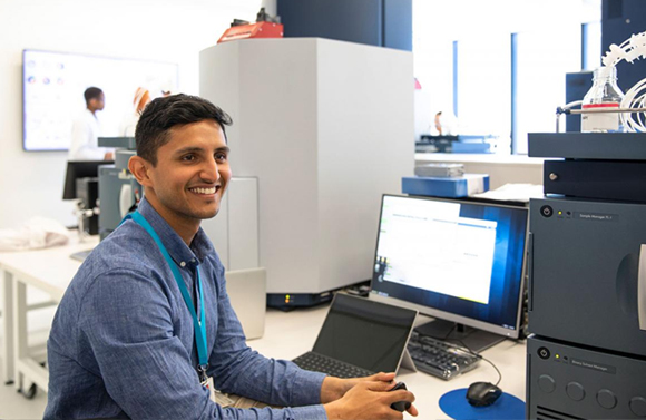 Happy employee smiling at computer