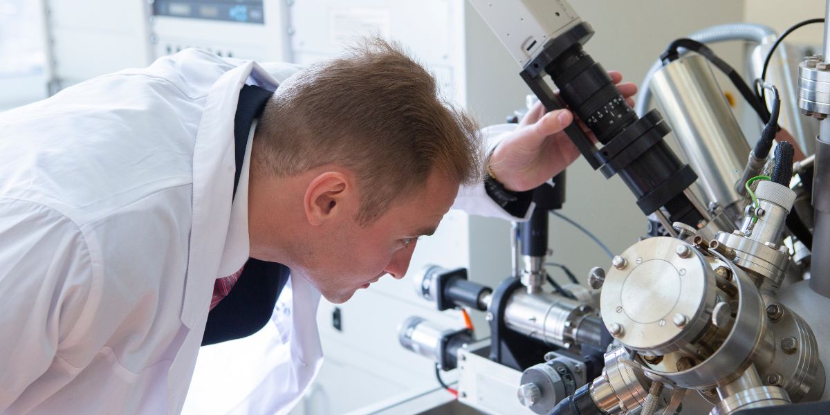 Scientist examining mass spectrometer